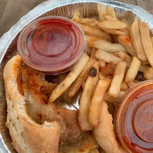 Meatball sub drenched in oil and fries that were partially cooked, and greasy.
