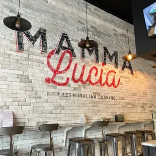 a brick wall and bar stools