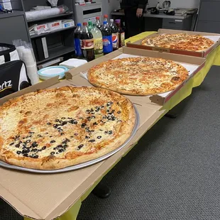 three pizzas on a table