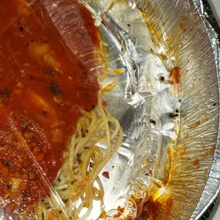 Collapsed lid with marsala juice mixed in angel hair pasta meat sauce