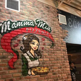 a woman holding a pizza