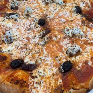 a pizza with olives and cheese
