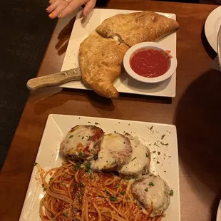 Philly cheese steak calzone (hand for size reference lol) and Fresh Eggplant Parmigiana