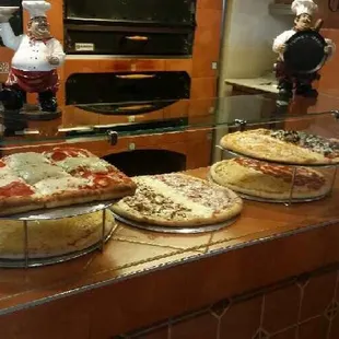 three pizzas on a counter