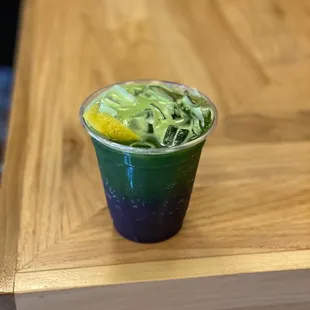 a cup of green and yellow food