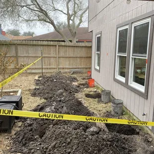 a pile of dirt in front of a house