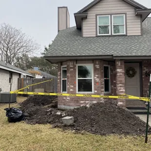 a pile of dirt in front of a house