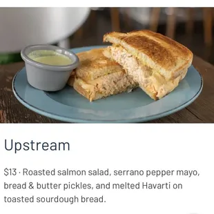 a plate with a sandwich and a bowl of mustard