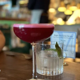 a cocktail in a glass with a garnish