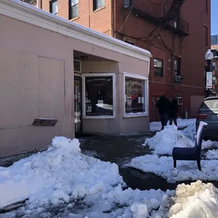 a man shoveling snow from the sidewalk