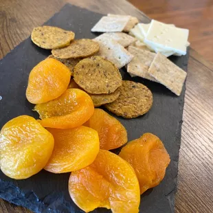 a plate of crackers, crackers, and apricots