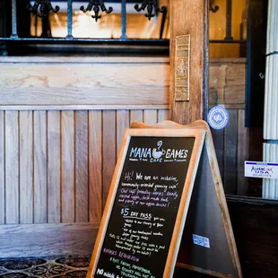 a chalkboard sign in front of a door