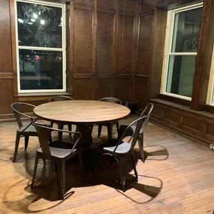 a table and chairs in a wood paneled room