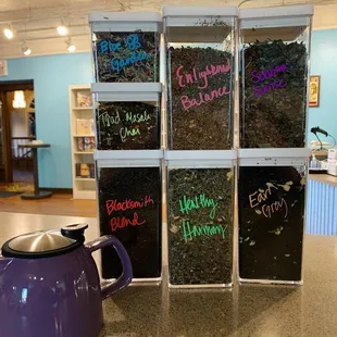 a purple teapot and a glass door with writing on it