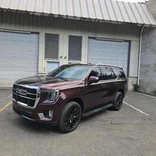 Full wrap 2024 GMC Yukon. Avery Passion Red. Original color, white.