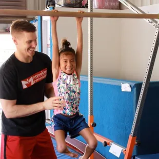 Bar hangs to practice grip strength for higher level bar skills.