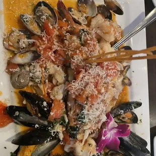 Mussels salmon clams over papedelli