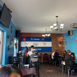 people sitting at tables in a restaurant