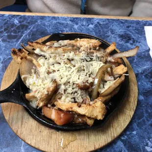 Chicken fajitas with shredded cheese.