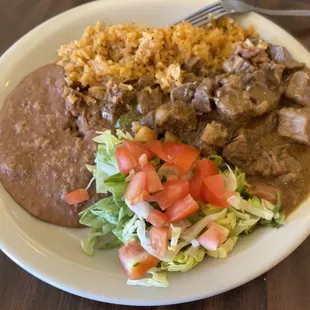 Mexican Lunch -114oz of carne guisada, spanish rice, refried beans, salad, and tortilla.