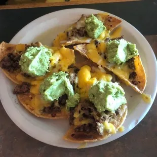 Loaded nachos with much more guacamole than expected.