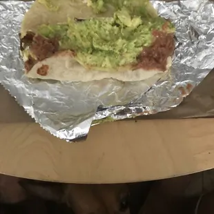 Basic breakfast taco; egg, beans, bacon and avocado