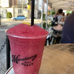 a pink drink in a plastic cup