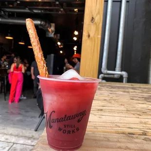 a red drink with a pretzel stick sticking out of it