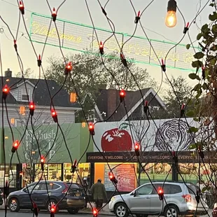 a city street with cars and christmas lights