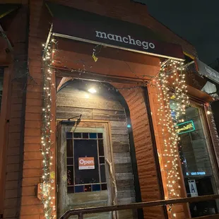 the front entrance of a restaurant at night