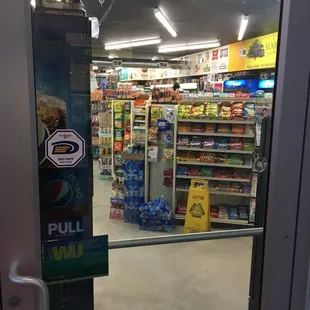a view of a grocery store through a glass door