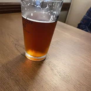 a pint of beer on a table