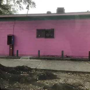 a pink building with a window