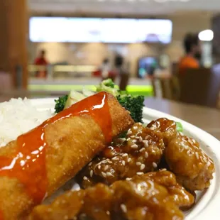 a plate of food with rice and broccoli