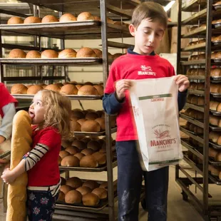 two children holding bread rolls