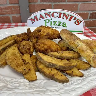 Broasted Chicken made with homemade seasoned breading, served with potato wedges and breadsticks