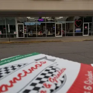 a pizza sitting in front of the store