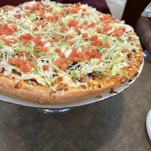 a whole pizza on a platter