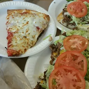 Steak Grinder (whole) with pickle spears, and a pepperoni pizza slice.