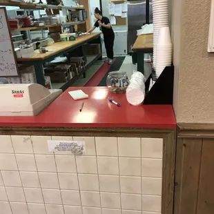 Saw her spraying with chemical cleaning directly at food AGAIN. As you can see her in this photo where she was wiping.