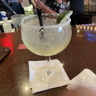 a margarita with a lime garnish