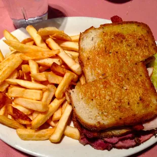 Classic Ruben Sandwich on Rye with French Fries.
