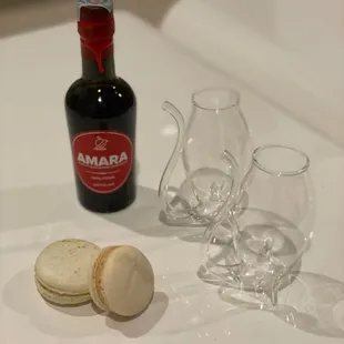 a bottle of amarra and two empty wine glasses