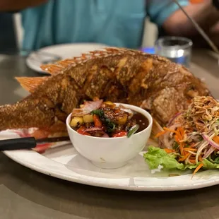 a plate of fish and salad