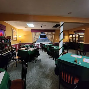a restaurant with green tables and chairs