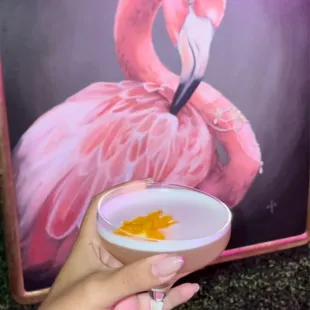 a pink flamingo with a crown on its head