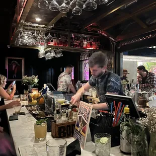 a bartender preparing a drink at a bar