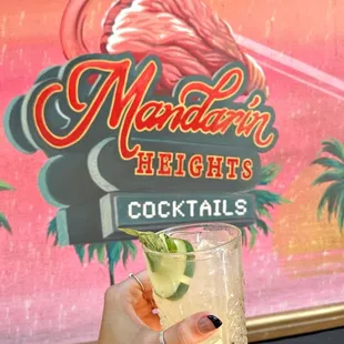 a woman holding a glass of cocktail