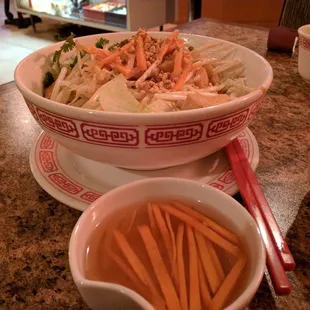 a bowl of noodles and a bowl of carrots