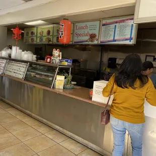 a woman standing in front of the counter